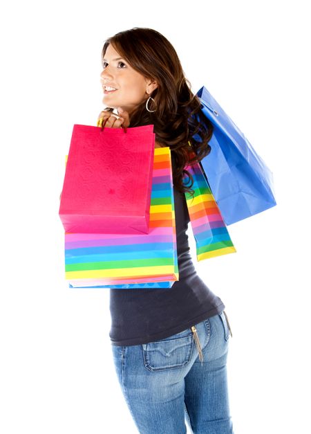 Thoughtful shopping woman with bags isolated over a white background