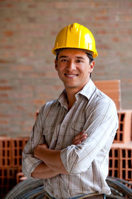 Male construction worker at a building site smiling