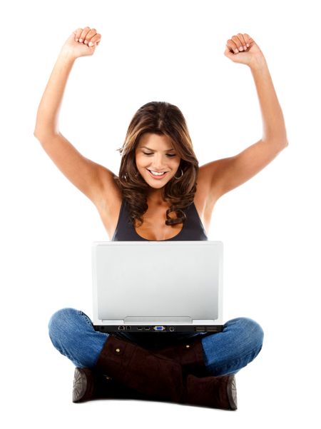 Woman with a laptop enjoying her online success - isolated over white