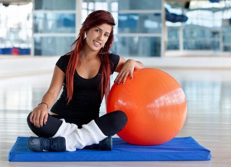 Young woman at the gym with a pilates ball