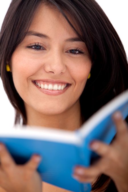Beautiful woman reading a book and smiling - isolated over white