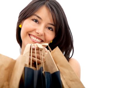 Shopping woman with bags smiling - isolated over a white background
