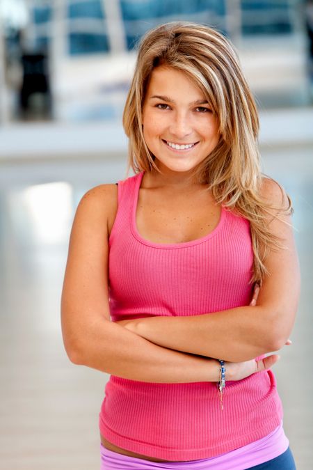 Beautiful woman portrait at the gym smiling