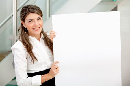 Beautiful business woman holding a banner at the office