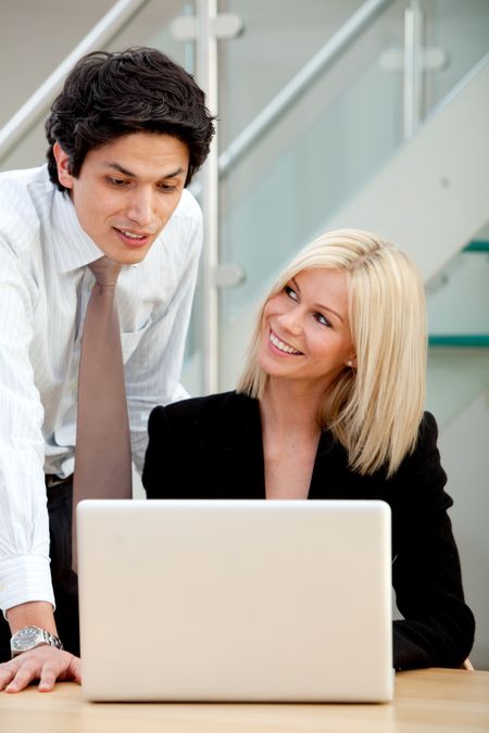 Business couple working on a laptop at the office