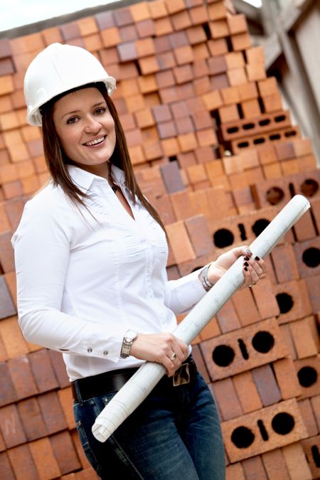 Female engineer with blueprints in a construction