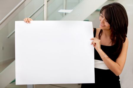 Business woman holding banner ad in her office