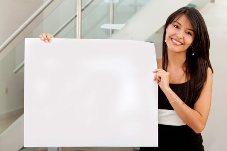 Business woman holding banner ad in her office