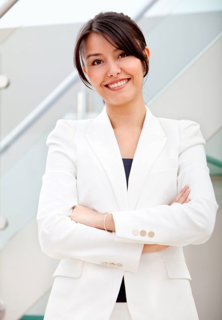 Friendly business woman smiling in her office