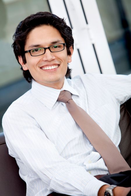 Friendly business man smiling in his office