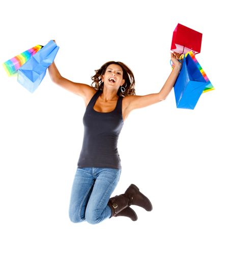 happy woman jumping with shopping bags isolated over a white background