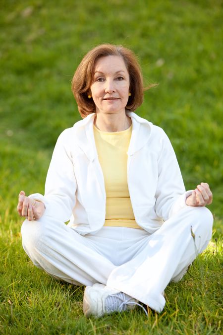 Woman doing yoga exercises in a tranquil location