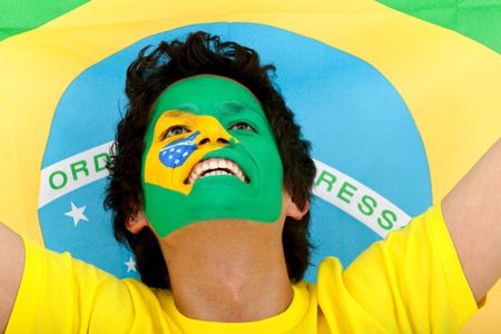 Portrait of a man with the brazilian flag painted on his face