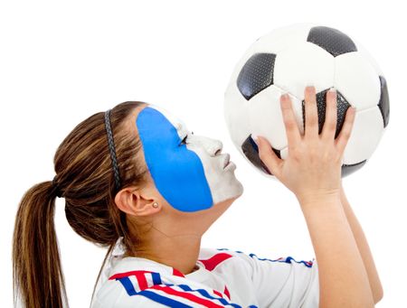 Portrait of a woman kissing a soccer ball with the french flag painted on her face isolated over white