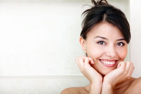Beauty portrait of a pensive female smiling at a bathroom