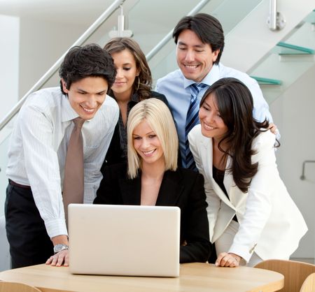 Group of business people on a laptop in an office