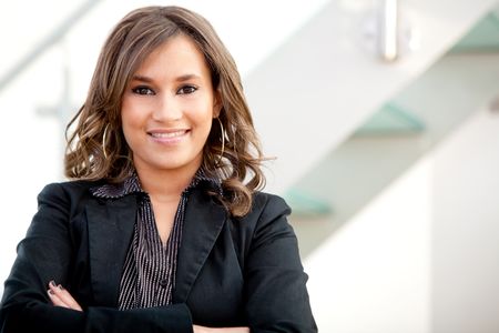 Friendly business woman portrait smiling in her office