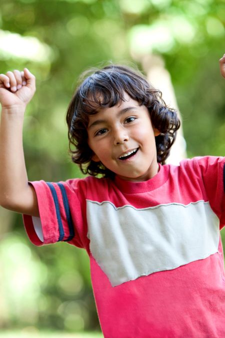 Little latinamerican boy playing outdoors and smiling