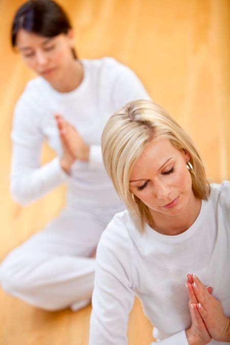 beautiful women doing yoga exercises in a tranquil location