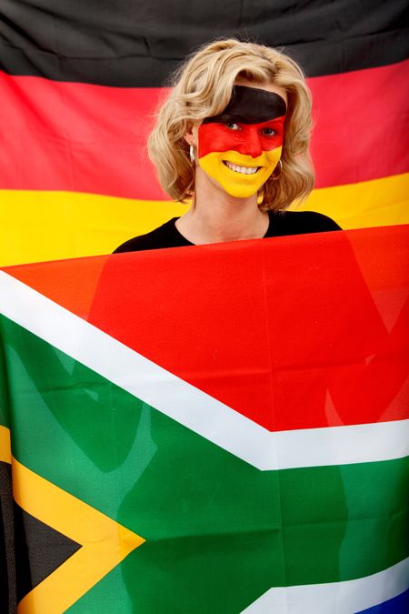 Portrait of a woman with the german flag painted on her face supporting her team in the southafrican world cup 2010