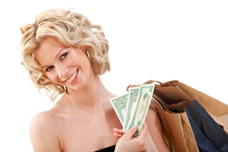 Beautiful woman holding money and shopping bags isolated over a white background