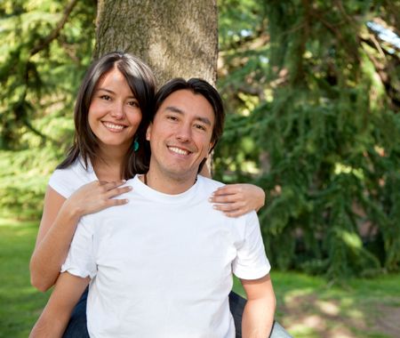 Family portrait of a brother and sister smiling outdoors