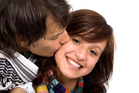 young couple smiling and standing next to each other - isolated over a white background