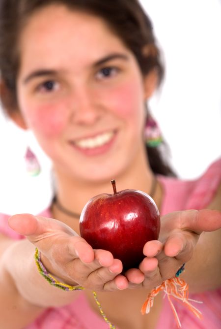 girl offering an apple while smiling over a white backgroudn