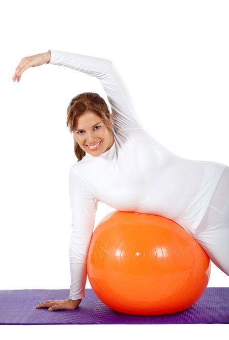 beautiful woman portrait exercising on a pilates ball - Isolated over a white background