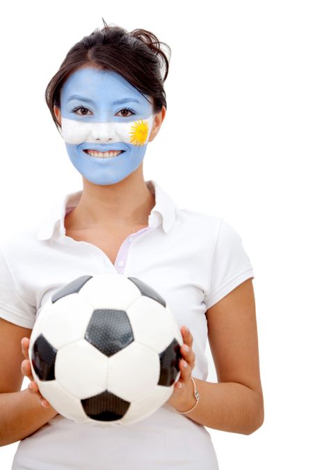 Portrait of a woman holding a soccer ball with the argentinian flag painted on her face - Isolated over a white background