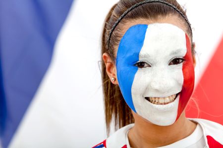 Portrait of a woman with the french flag painted on her face