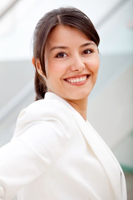 Friendly business woman portrait smiling in her office