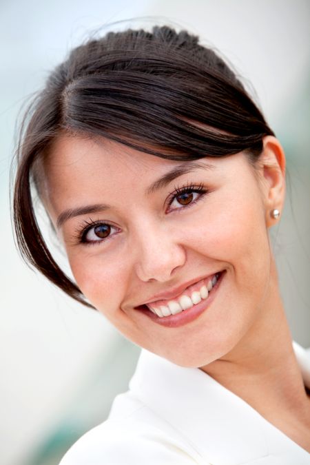 Friendly business woman portrait smiling in her office