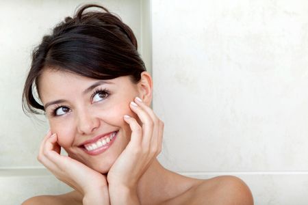 Beauty portrait of a female smiling at a bathroom