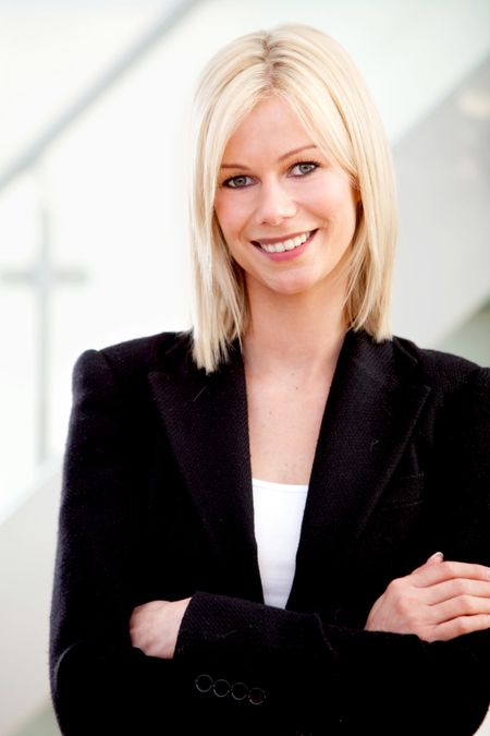 Friendly business woman portrait smiling in her office