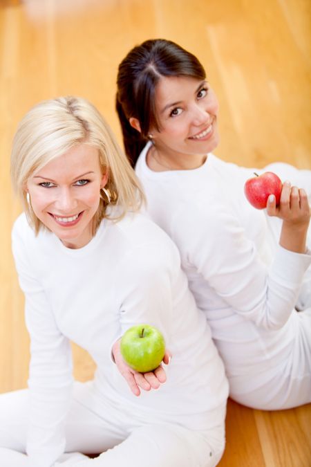 Healthy eating women smiling and holding apples on their hands