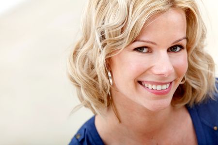 Beautiful blonde caucasian woman portrait smiling indoors
