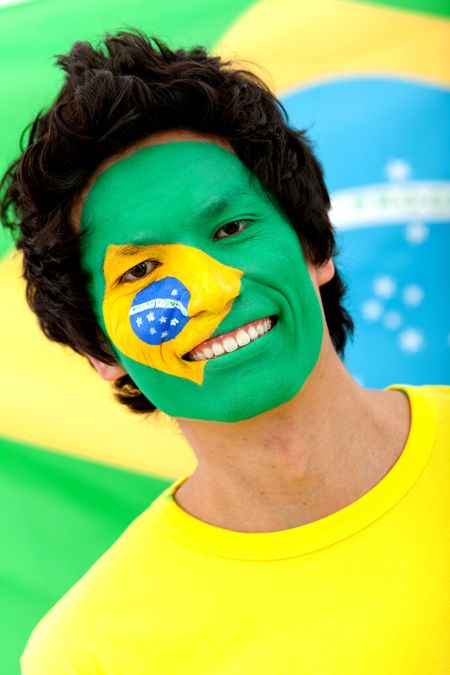 Portrait of a man with the Brazilian flag painted on his face