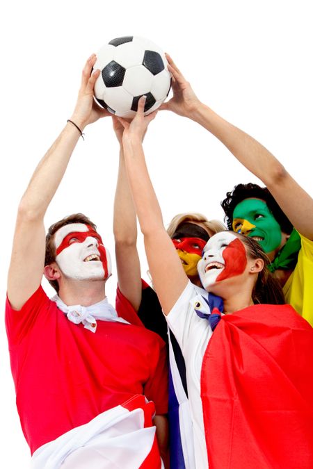 Football fans with flag painted on their faces lifting a ball - isolated over a white background