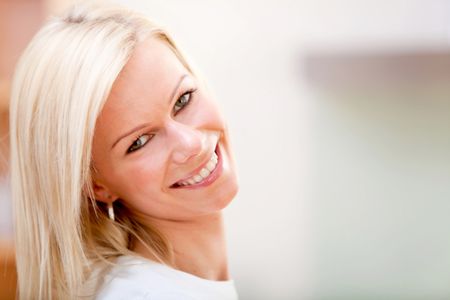 Portrait of a beautiful blonde woman smiling indoors