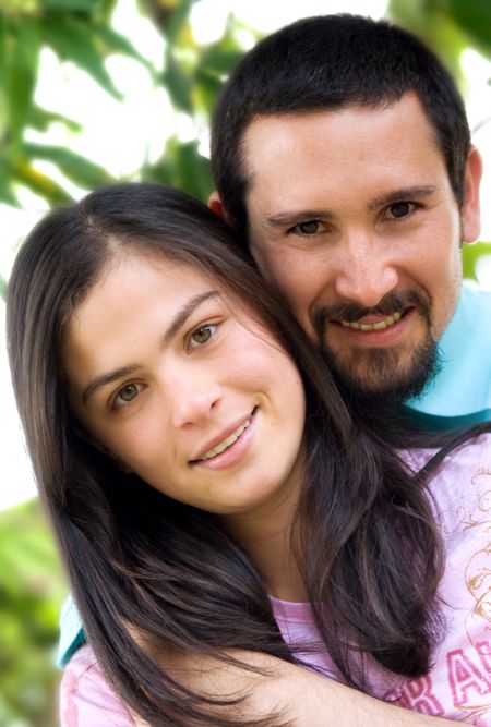 couple of lovers portait smiling outdoors in a park