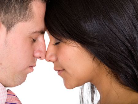 Beautiful couple with eyes closed while facing at each other