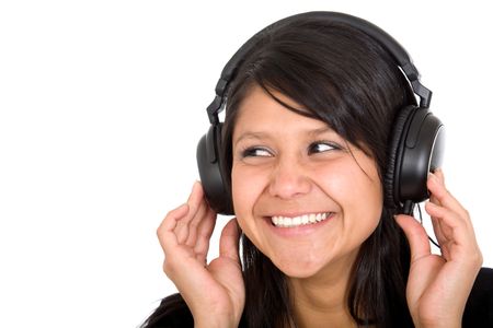 girl listening to music with headphones smiling over a white background