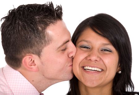 guy kissing his girlfriend on a cheek over a white background