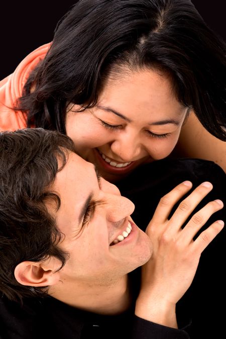 couple having fun over a black background