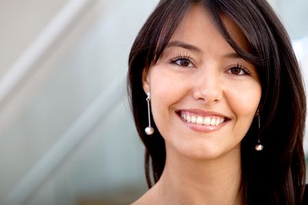Friendly business woman portrait smiling in her office