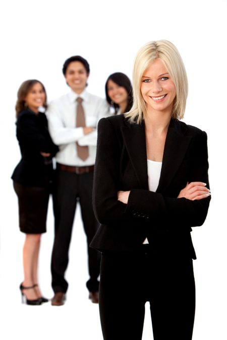 Business woman smiling with her team behind her - isolated over white