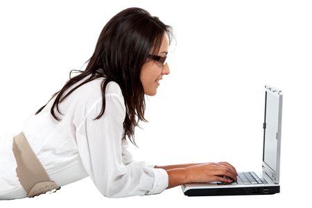 Woman working on a laptop isolated over a white background