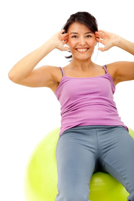 Woman exercising with a pilates ball isolated over a white background