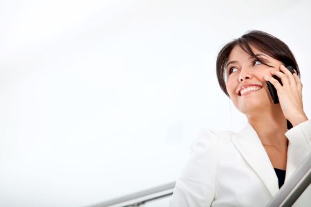 Business woman talking on the phone and smiling - isolated